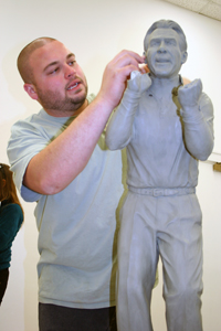 Jeremy K. Davis, undergrad BFA major in art, sculpting the maquette used to cast Coach Saban's statue.