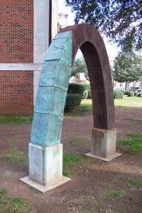 "Pent/La Buidhe Bealltain" by George Beasley, 80 x 82 x 15.5 inches; cast iron and cast bronze. Located at the northwest corner of the Bureau of Mines Building on the University of Alabama campus, this work won the 1991 Purchase Award at the Alabama Biennial. 