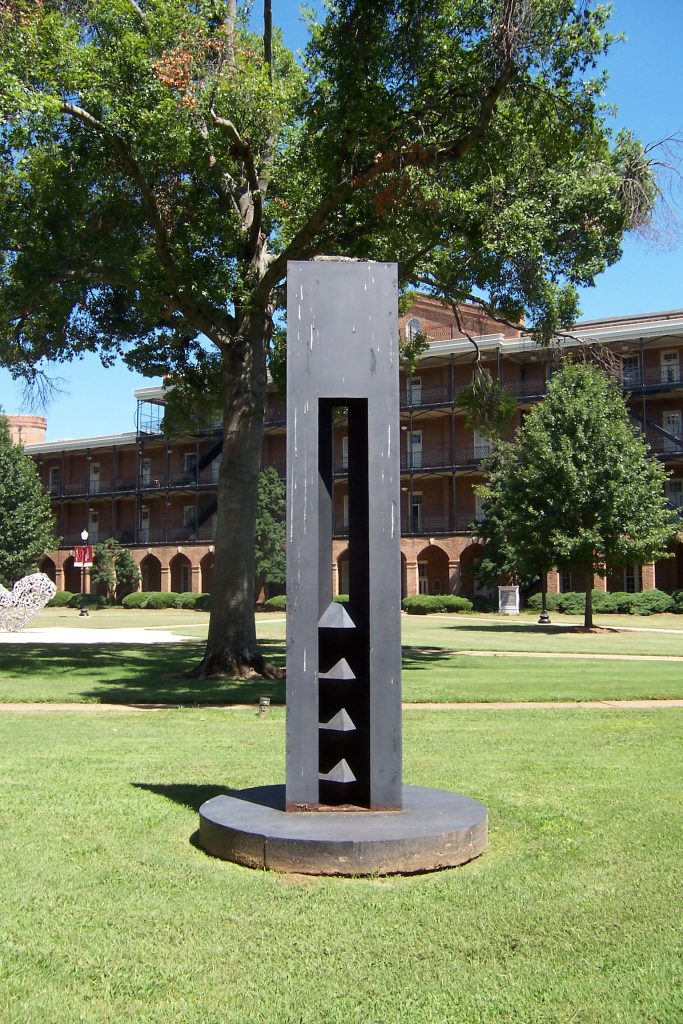 a tall, narrow metal sculpture