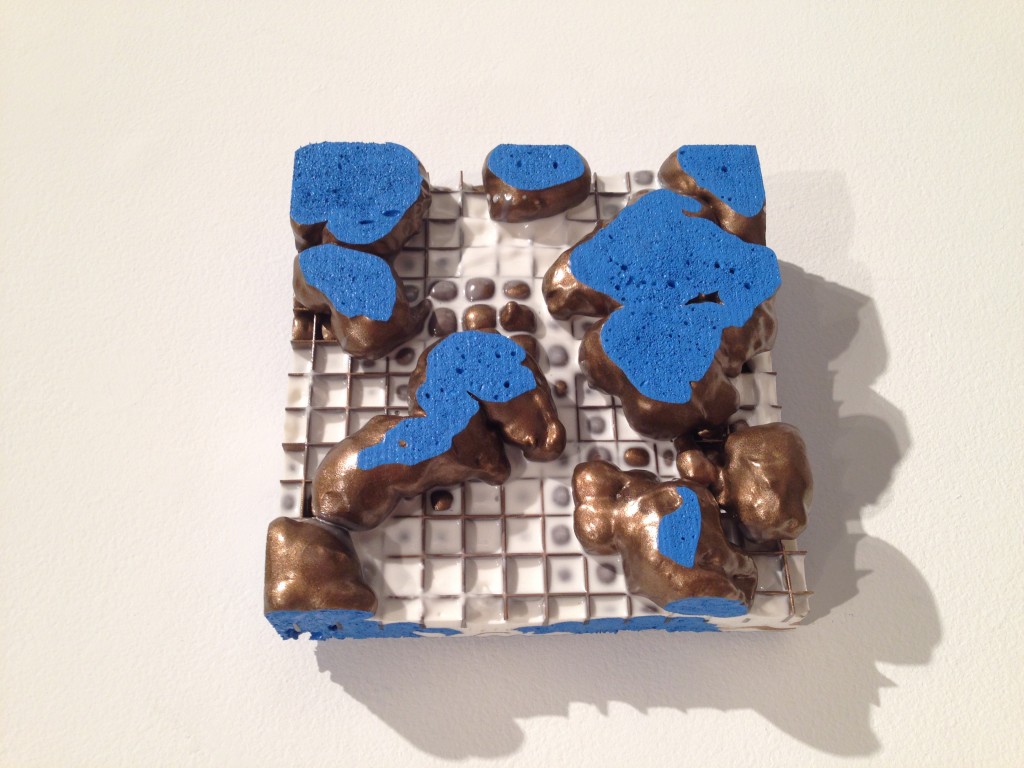 ceramic artwork with islands of blue atop a grid