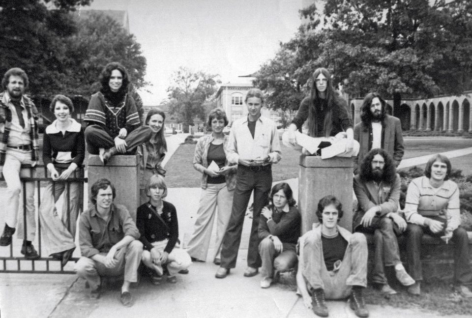 members of the graduate class of 1976 posing in Woods Quad