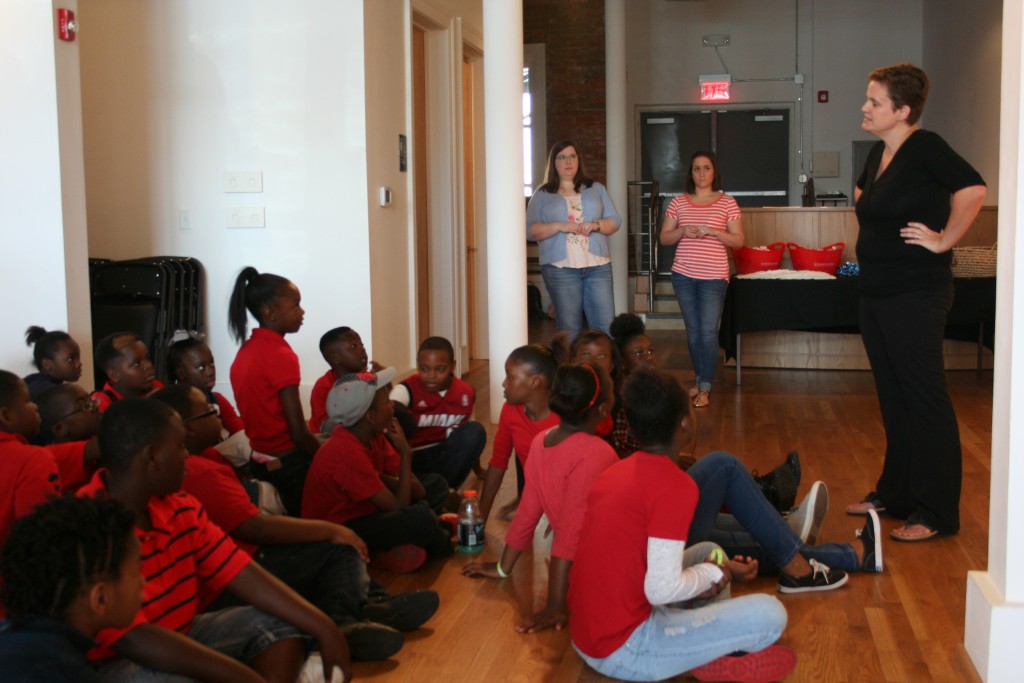 Dr. Lucy Curzon discusses artworks with middle and elementary kids at the Paul Jones Gallery.