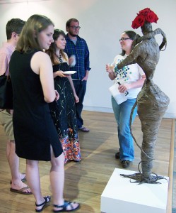 Ali Jackson (center) talking with visitors at her BFA exhibition at Harrison Galleries.