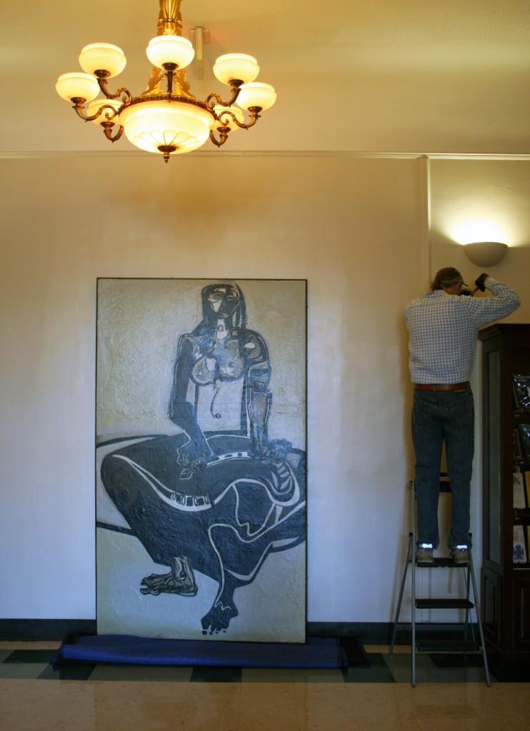 Bill Dooley measures the space for hanging "Cassandra" by Ben Smith