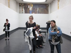 several students gathered in a gallery space