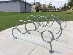 Bike racks installed at Alberta Park, built by UA art alumni.