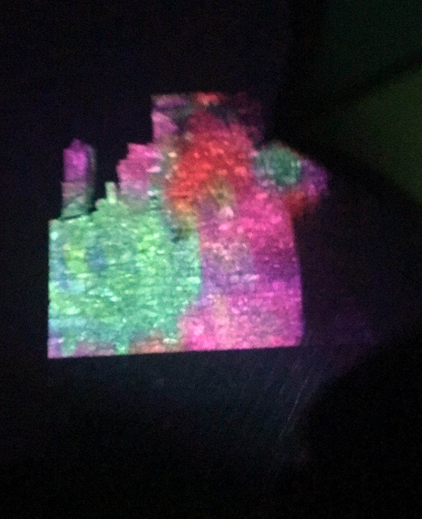 Multi-colored projection-mapping onto O'Brien's Castle on Inis Oírr by Jane Cassidy.