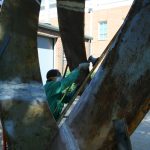 Paget Kern working on her sculpture, "Mobius and Borromean Rings," welded steel, now in the Woods Quad Sculpture Garden
