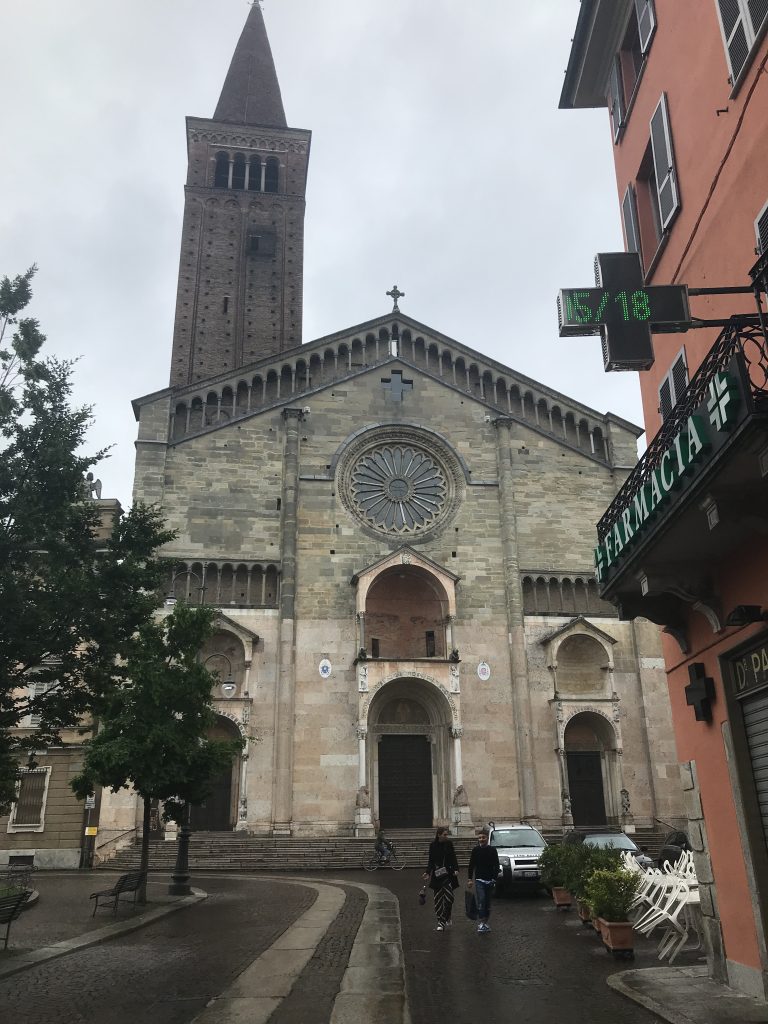 View of Piacenza Cathedral facade (and the pharmacia in front). The work in the south portal (at the right, here) is attributed to Niccolò around 1122. Study Abroad, May 2018. Photo by Rebecca Teague.