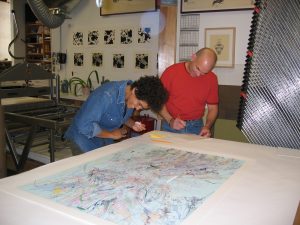 Artist Julie Mehretu and master printer Cole Rogers work on her print exhibition. Mehretu's prints are on exhibit in the Sarah Moody Gallery of Art, January 24 through March 8, 2019.