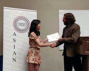 Dr. Steven Ramey presents the 2019 Asian Studies Essay Award to art major Sarah Fields.