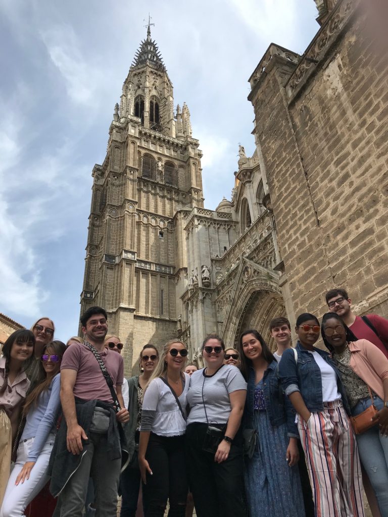 Art and Art History students and faculty stand before the Cathedral of Saint Mary in Toledo.