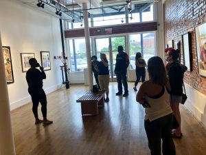 Visitors look at artwork in a gallery