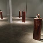 gallery with six pedestals with small bronze sculptures