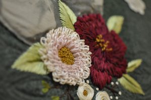 detail of embroidered flowers on a quilt